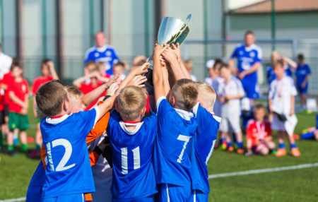 photo of a soccer team winning a trophy