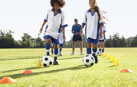 child soccer players performing agility drills