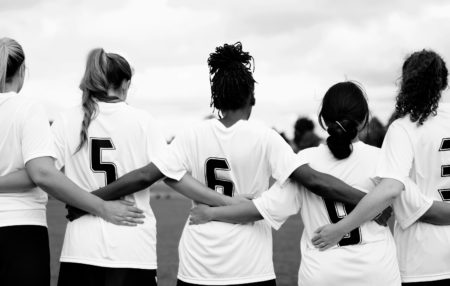 photo of a youth soccer team linking arms