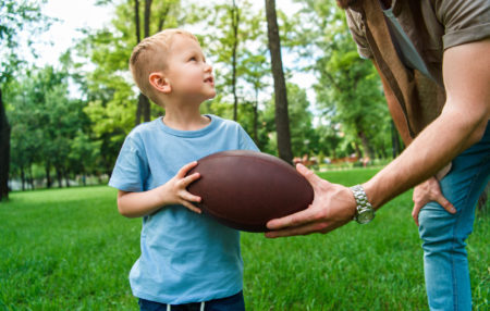 photo of a little boy holding a football