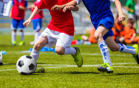 photo of children playing soccer