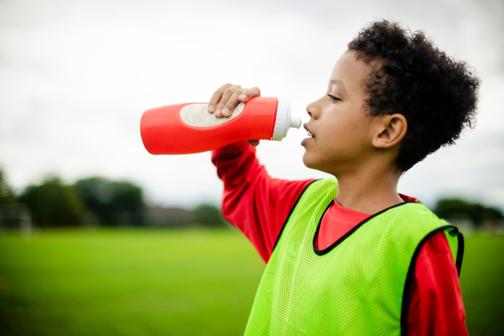 photo of a child drinking from a waterbottle