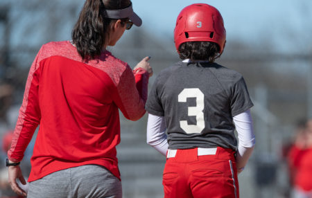 baseball coach talking to her player