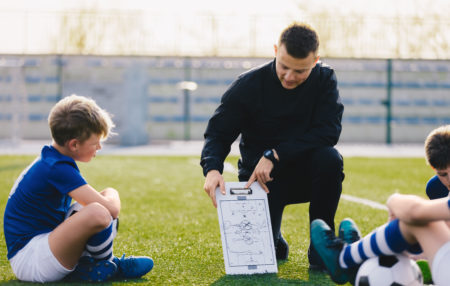 youth soccer coach going over plays